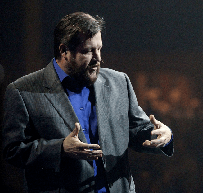 a man wearing a suit and tie talking on a cell phone